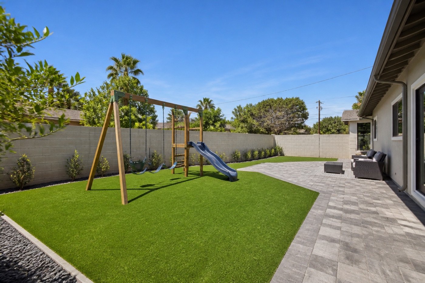 Playground turf installation under a backyard play set in Encino