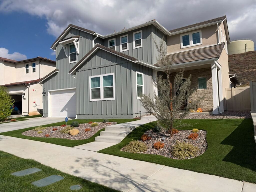 Drought-tolerant rock garden beds and artificial turf in a Santa Clarita front yard