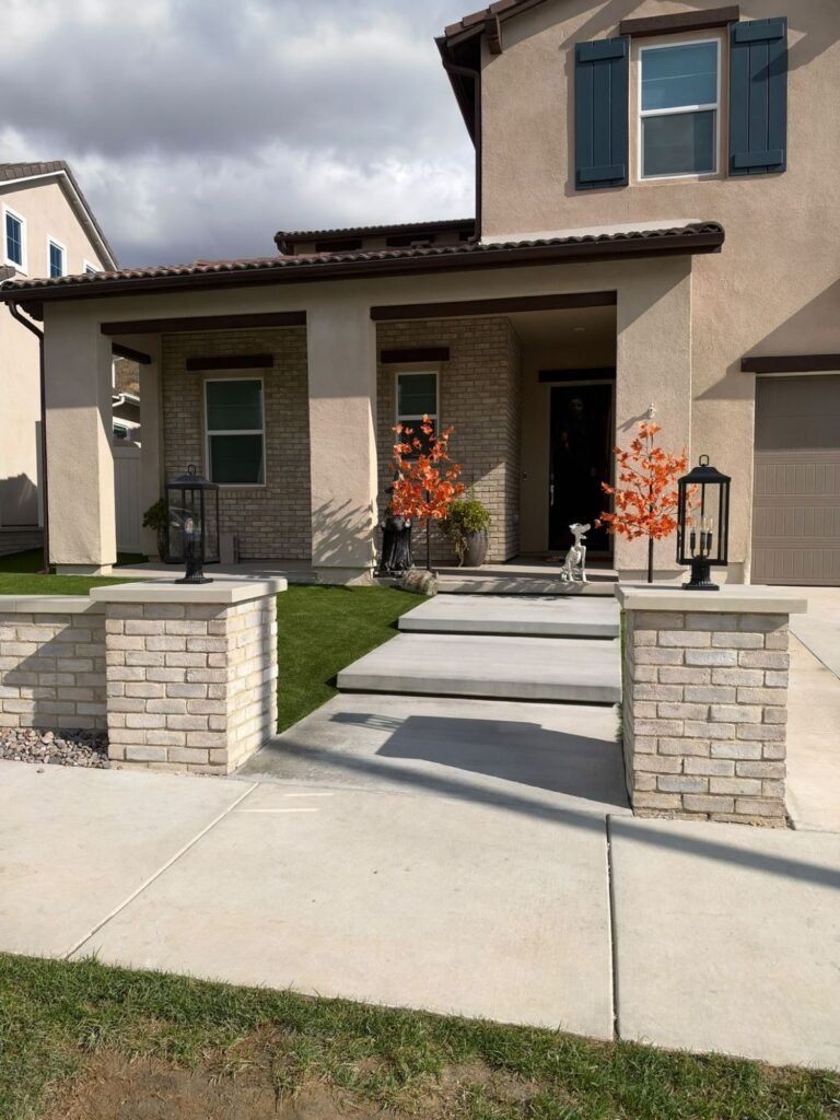 Floating concrete steps between brick pillars with post lanterns in Santa Clarita