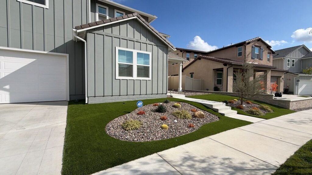 Front yard artificial turf with a drought-tolerant rock garden in Santa Clarita by Option 1 Builders