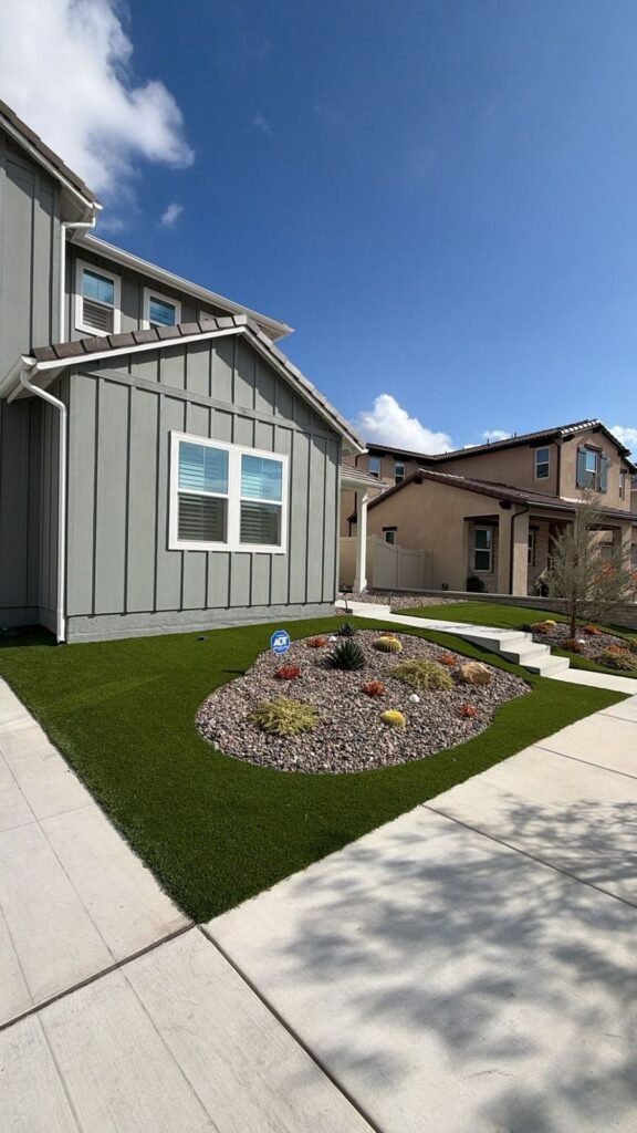 Rock garden with succulents and cactus surrounded by artificial turf in Santa Clarita