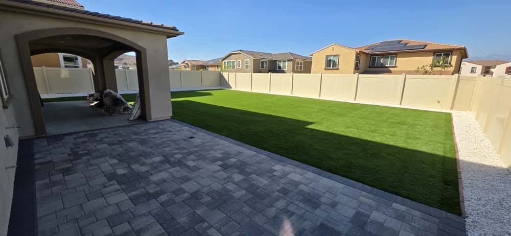 Backyard artificial turf lawn and paver patio in Sherman Oaks