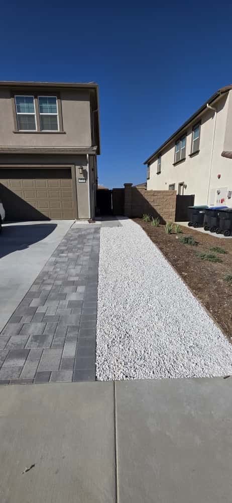 Paver strip and white gravel beside a driveway in Sherman Oaks