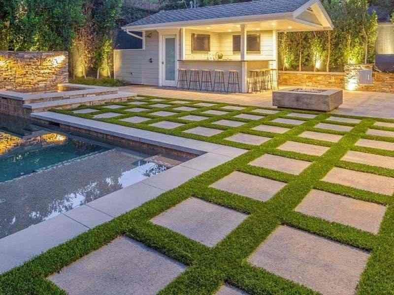 Paver and turf patio with pool deck and outdoor bar